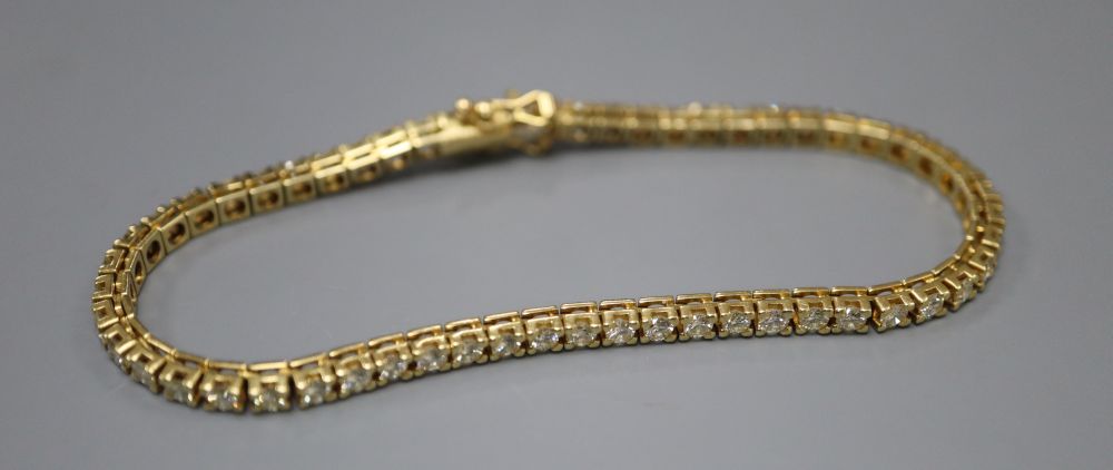 A modern Italian 18ct gold and diamond set line bracelet, 18.8cm, gross 13.7 grams,